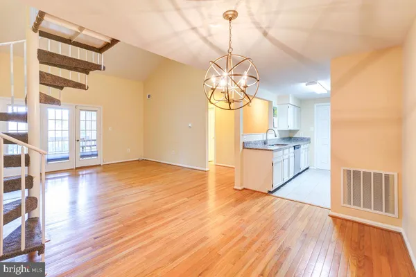 a view of a kitchen with a sink and wooden floor