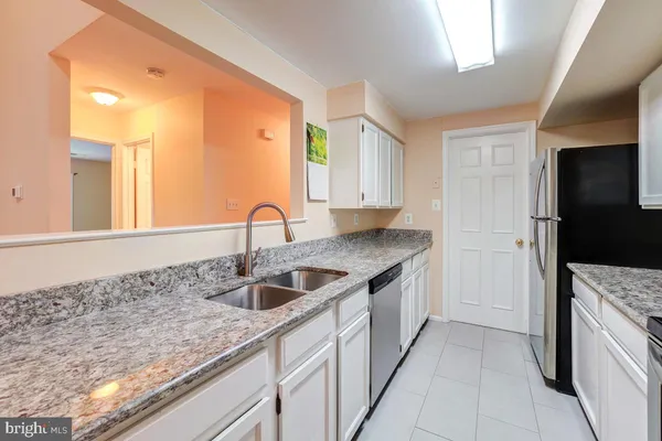 a kitchen with a sink and a refrigerator