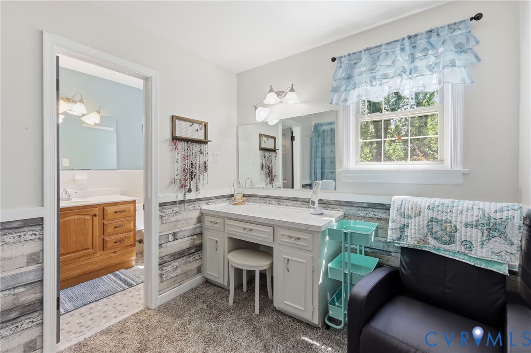 11200 Surry Road Chester, VA 23831 - Photo 25 of 48 a spacious bathroom with a granite countertop sink and a mirror