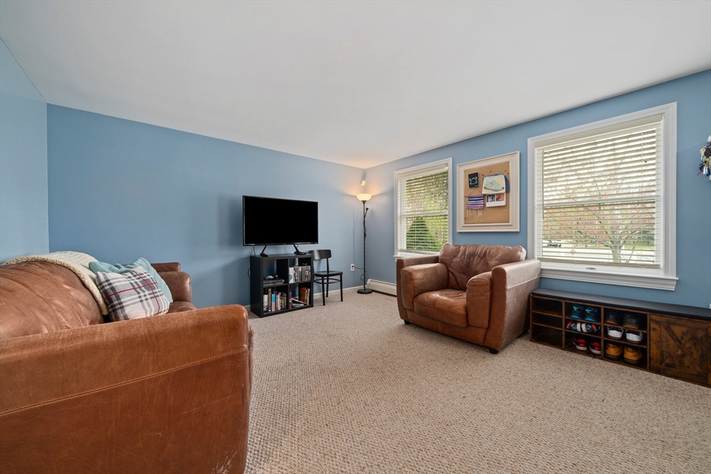 80 King Street Hanover, MA 02339 - Photo 13 of 34 a living room with furniture and a flat screen tv