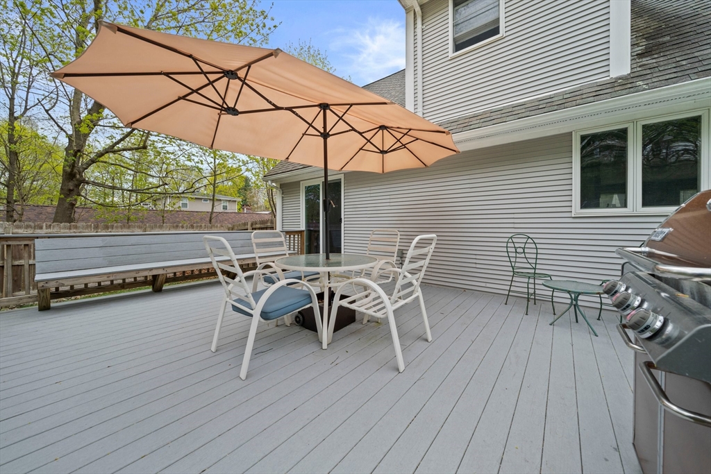 80 King Street Hanover, MA 02339 - Photo 28 of 34 a view of a patio with table and chairs with wooden floor and fence