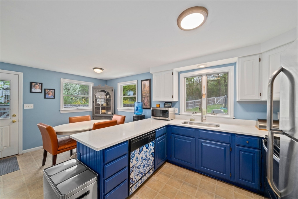 80 King Street Hanover, MA 02339 - Photo 4 of 34 a kitchen with wooden cabinets and sink