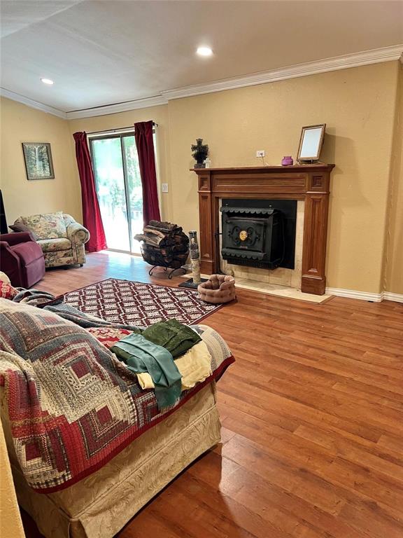 87 County Road Powderly, TX 75473 - Photo 7 of 9 Living area featuring recessed lighting, baseboards, crown molding, and wood finished floors