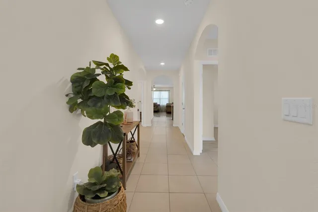 a vase of flowers sitting on a floor