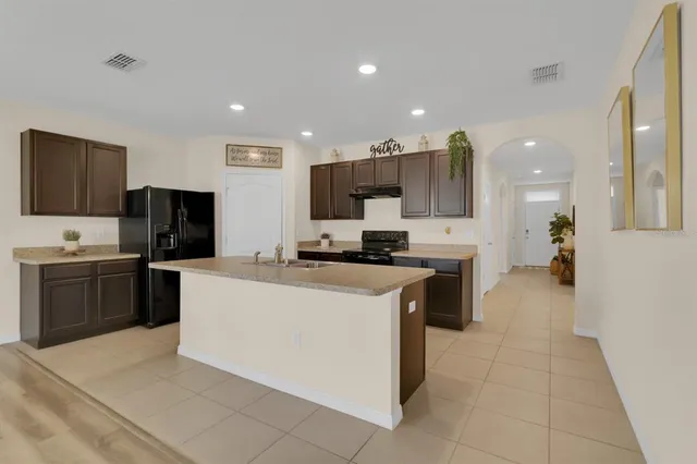 a kitchen with kitchen island counter top space cabinets and stainless steel appliances