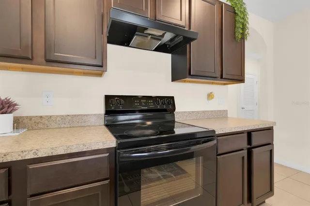 a kitchen with granite countertop a stove and a sink