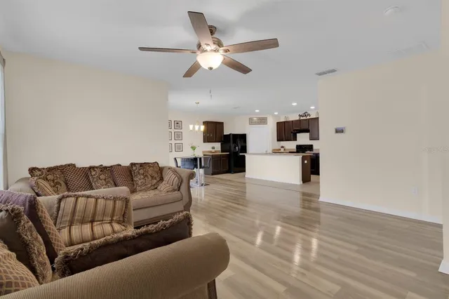 a living room with furniture and kitchen view