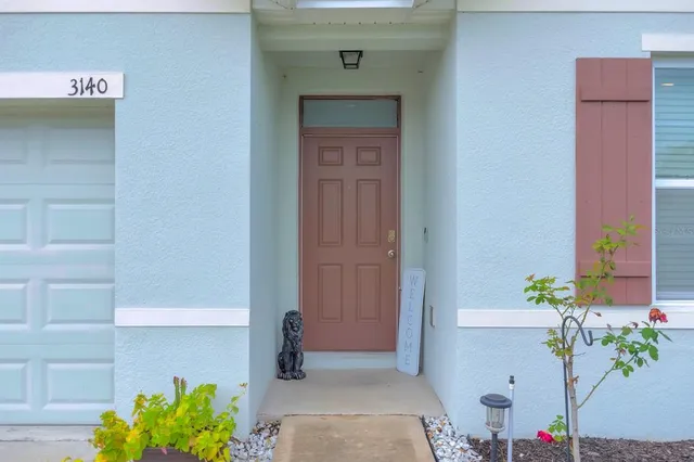 a hallway with painting and flowers