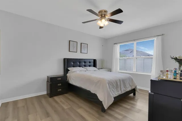 a bedroom with a large bed and a chandelier