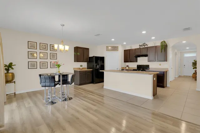 a living room with furniture and kitchen view