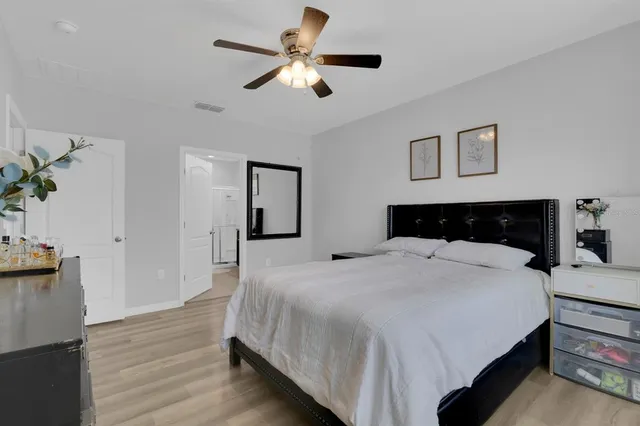 a bedroom with a bed and wooden floor