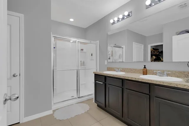 a bathroom with a double vanity sink and mirror