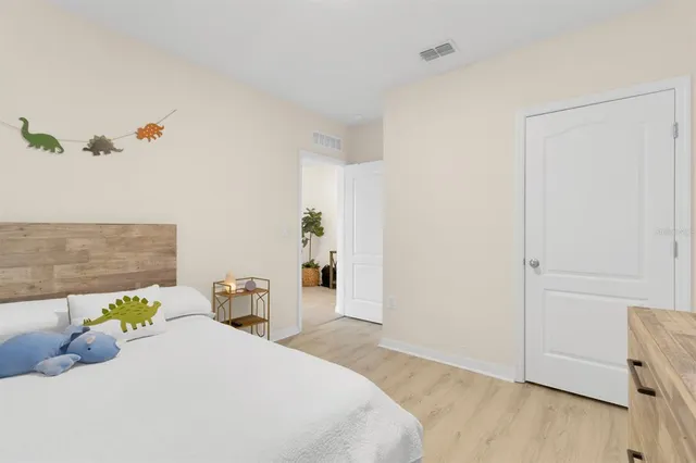 a bedroom with a bed and ceiling fan