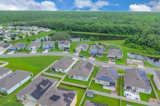 an aerial view of a houses with a yard