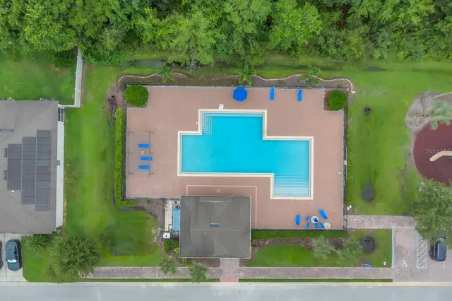 an aerial view of a house with a yard and lake view
