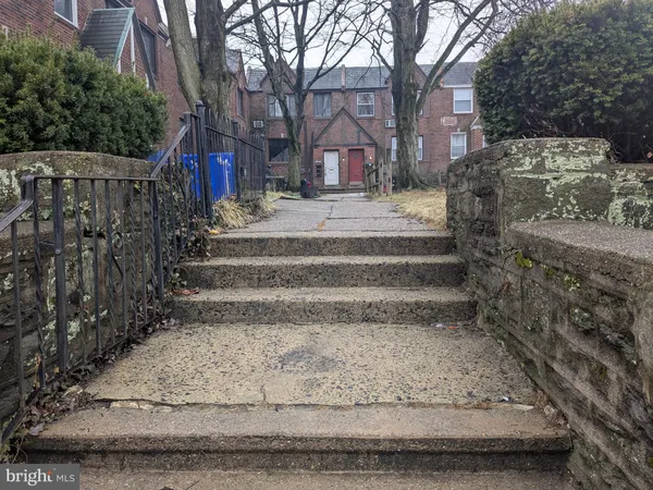 a view of pathway with a wrought fence