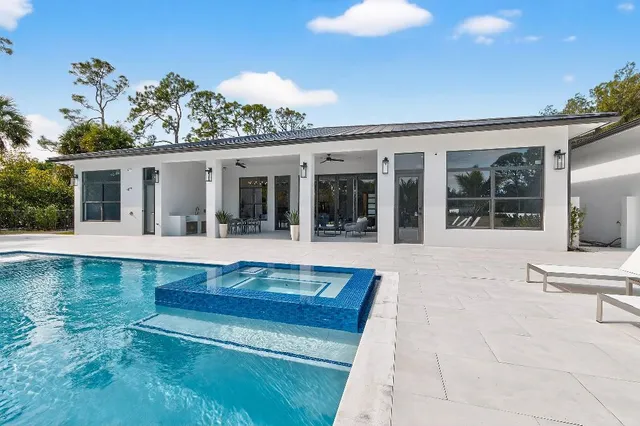 a view of house with swimming pool and porch