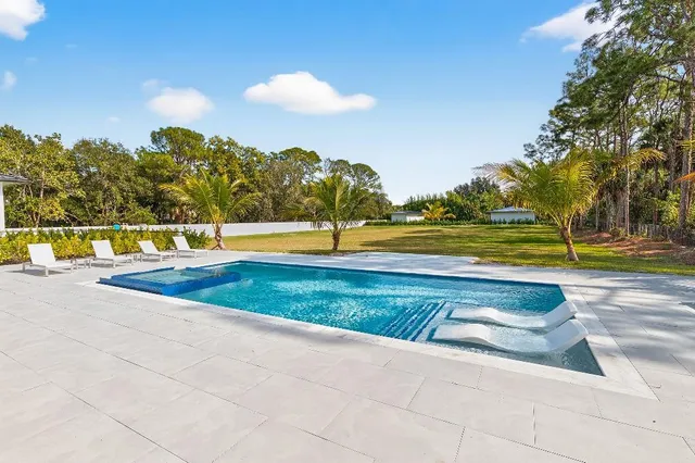a view of yard with swimming pool and an outdoor space