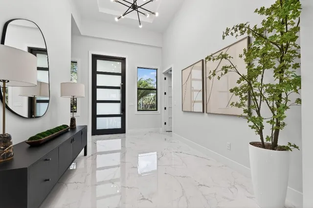 a hallway with a stove a mirror and cabinets