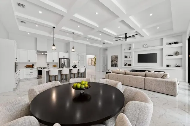 a living room with lots of furniture and kitchen view