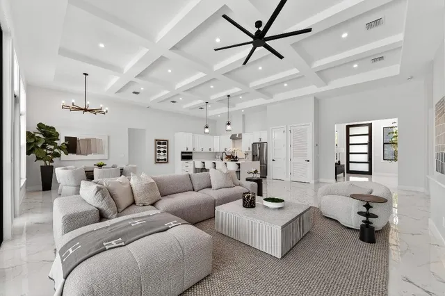 a living room with furniture and a chandelier