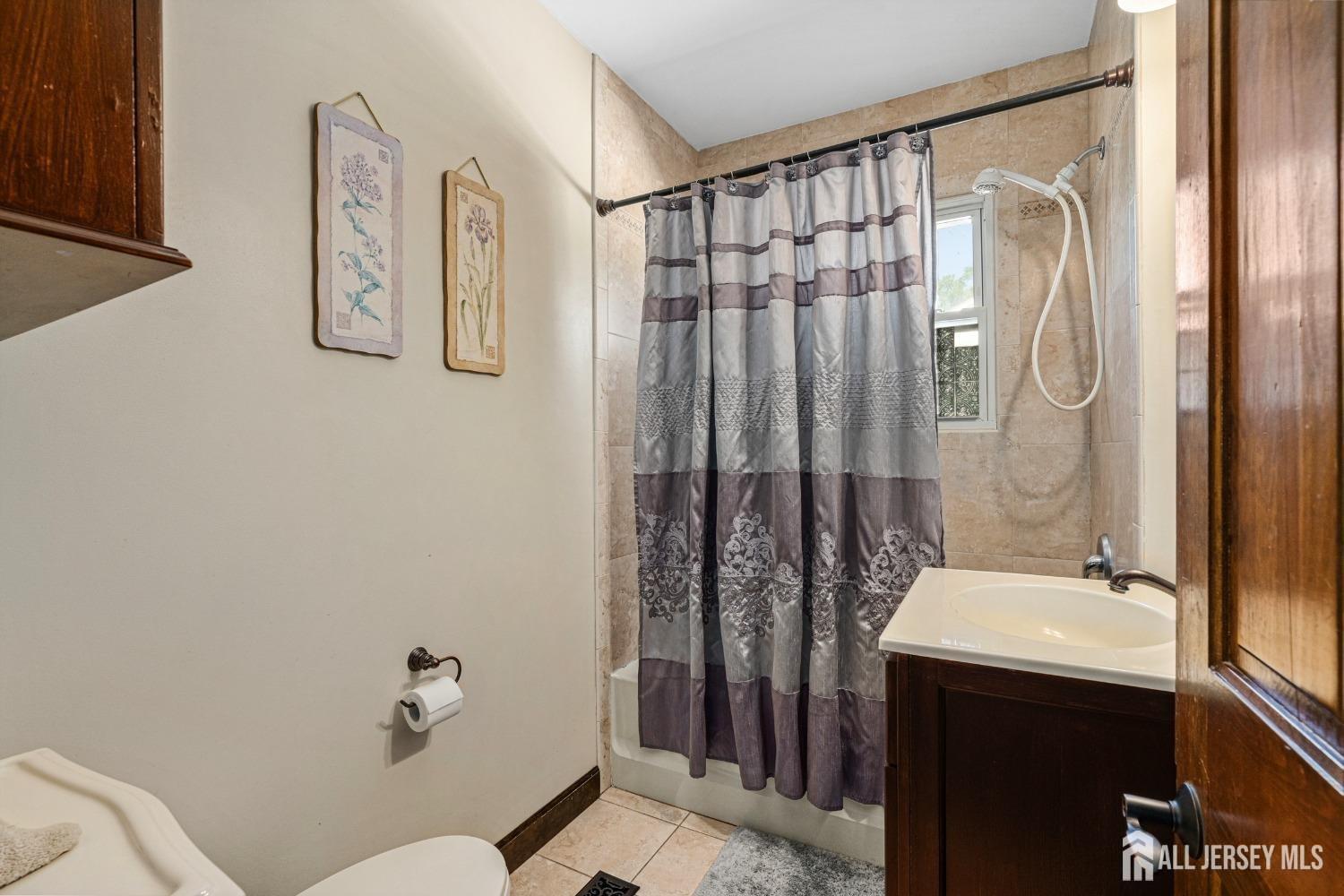 23 Reed Street Edison, NJ 08817 - Photo 11 of 21 a bathroom with a sink and mirror with toilet