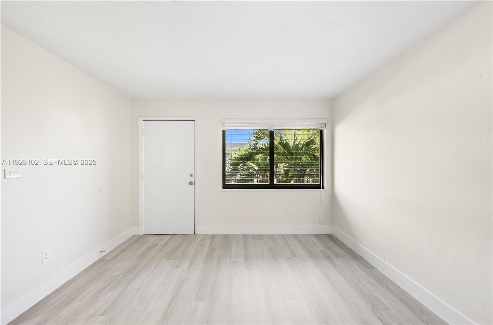 1330 West 29th Street, Unit 33 Hialeah, FL 33012 - Photo 1 of 18 a view of a room that has wooden floor and window