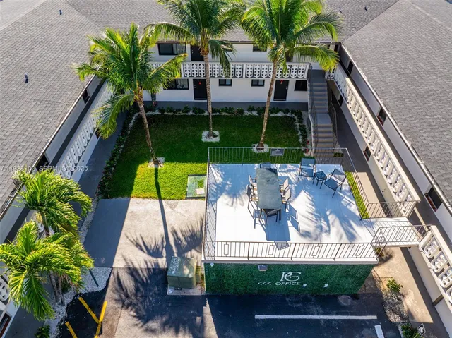 a view of a house with swimming pool and sitting area