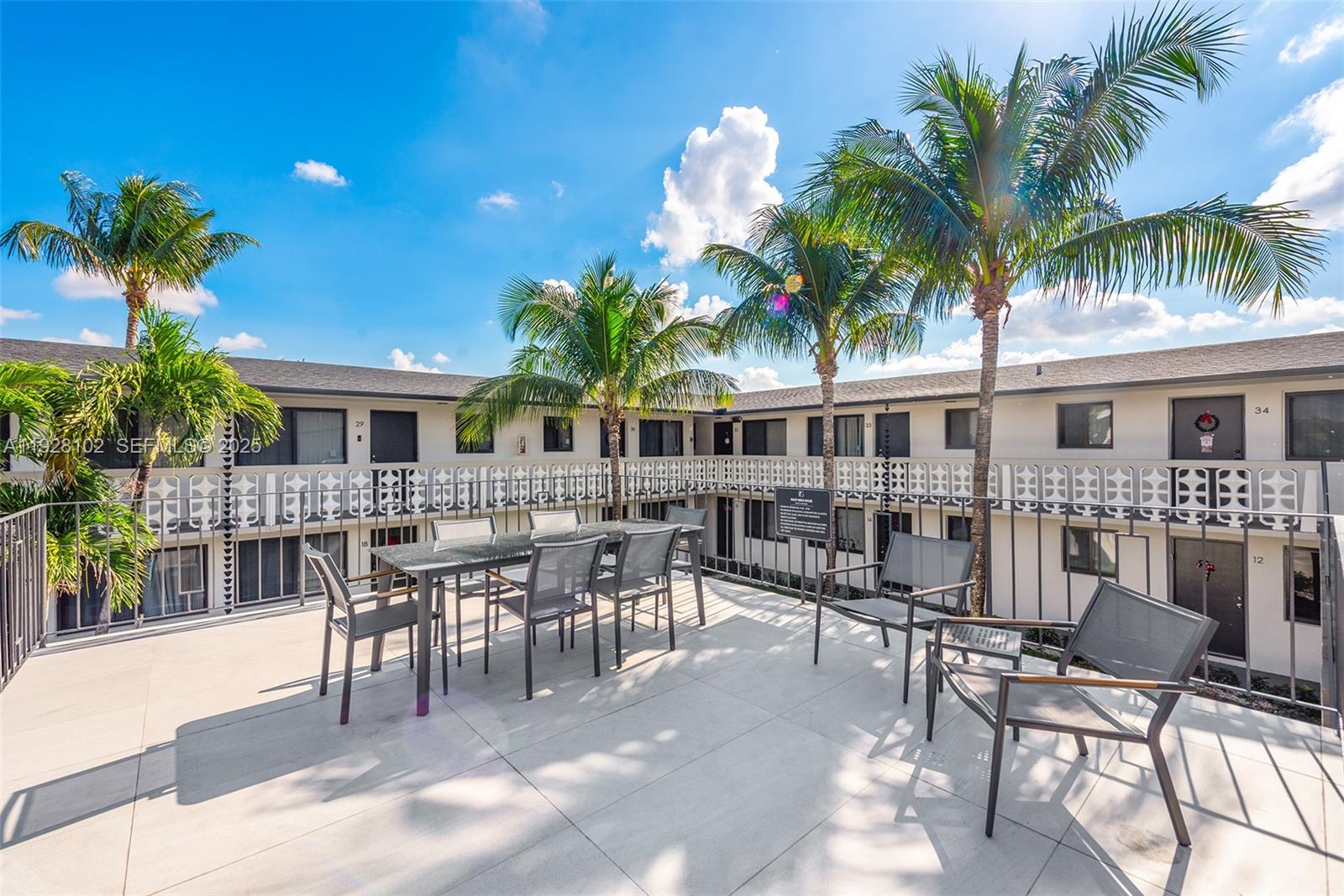 1330 West 29th Street, Unit 33 Hialeah, FL 33012 - Photo 15 of 18 a view of a patio with a dining table and chairs with plants