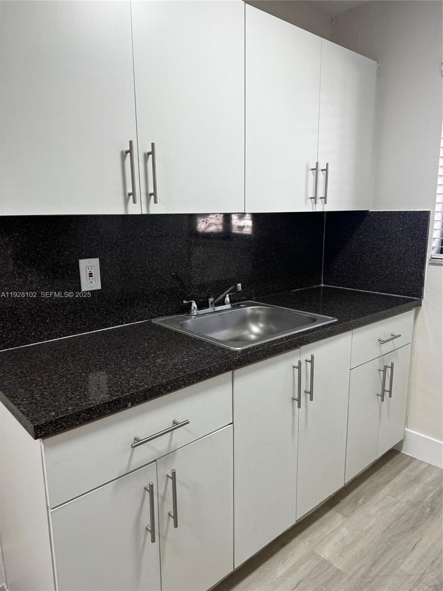 1330 West 29th Street, Unit 33 Hialeah, FL 33012 - Photo 18 of 18 a kitchen with a sink and cabinets