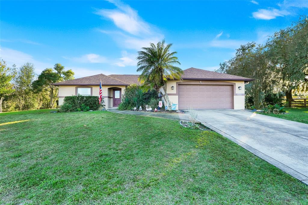 13330 Georgia Avenue Astatula, FL 34705 - Photo 2 of 16 a front view of house with yard and green space