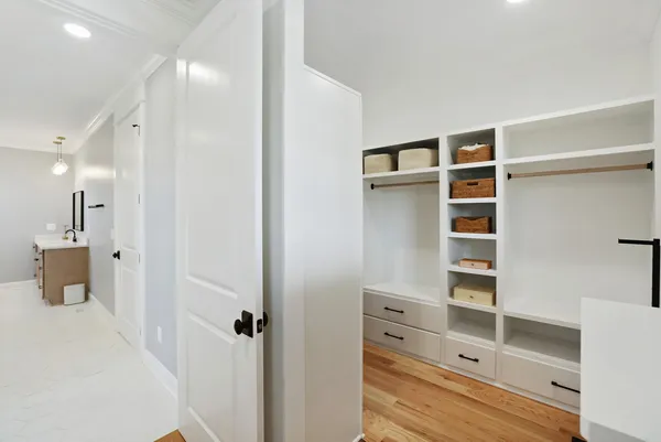 a bedroom with furniture and a flat screen tv