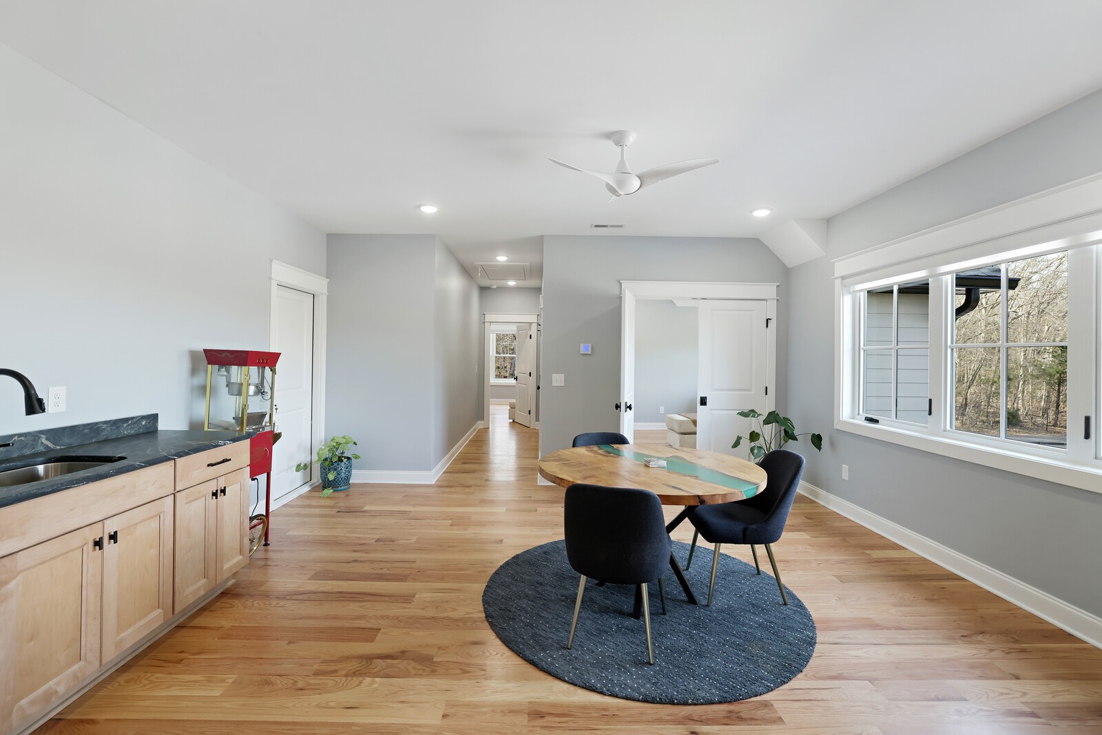 3755 Holmes Gap Road Watertown, TN 37184 - Photo 28 of 71 a dining room with wooden floor a chandelier a glass table and chairs