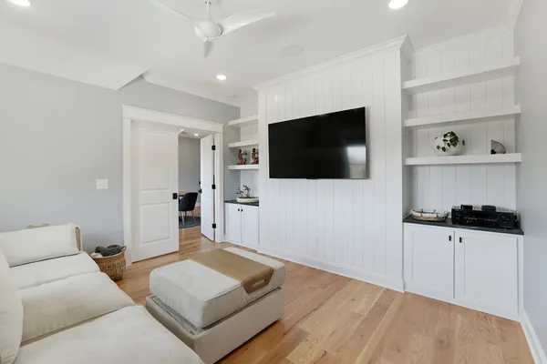 a living room with furniture and wooden floor