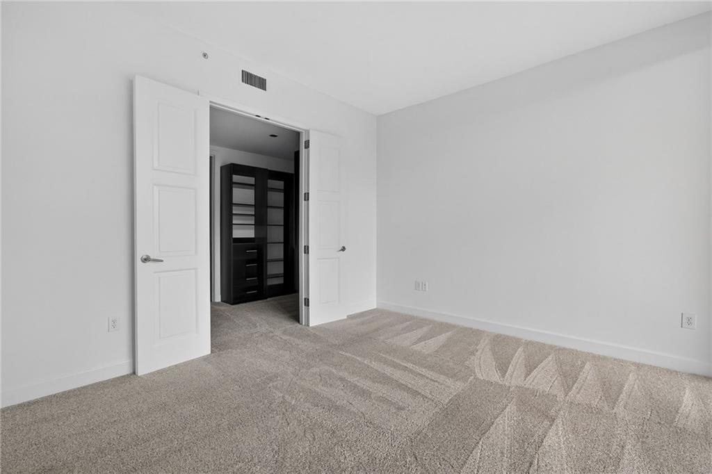 1820 Peachtree Road Northwest, Unit 312 Atlanta, GA 30309 - Photo 26 of 51 an empty room with an entryway and closet
