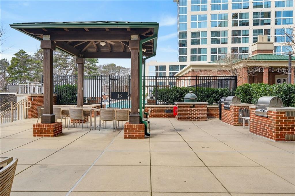 1820 Peachtree Road Northwest, Unit 312 Atlanta, GA 30309 - Photo 35 of 51 a outdoor space with patio the couches and a dining table with the garden view