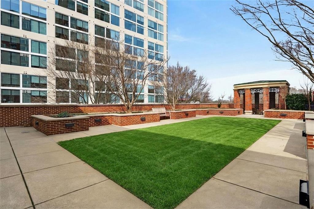1820 Peachtree Road Northwest, Unit 312 Atlanta, GA 30309 - Photo 38 of 51 a front view of a building with garden and trees
