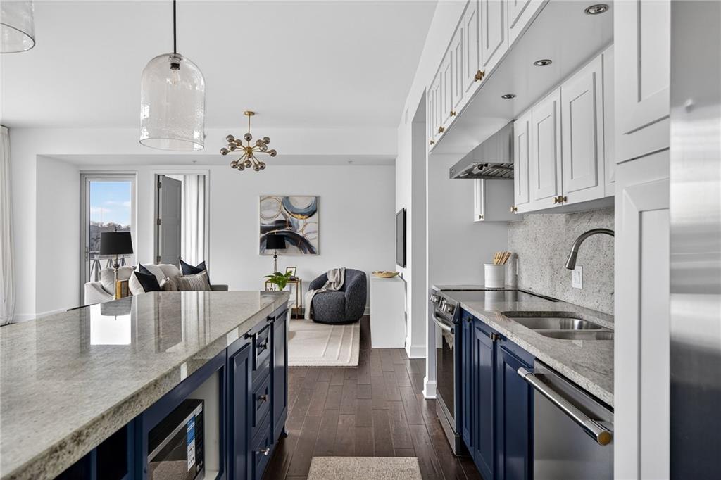 1820 Peachtree Road Northwest, Unit 312 Atlanta, GA 30309 - Photo 5 of 51 a kitchen with stainless steel appliances granite countertop a sink a stove and refrigerator