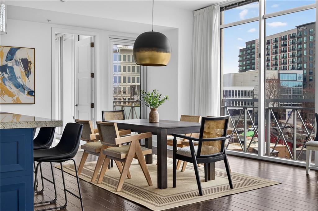 1820 Peachtree Road Northwest, Unit 312 Atlanta, GA 30309 - Photo 7 of 51 a dining room with furniture and wooden floor