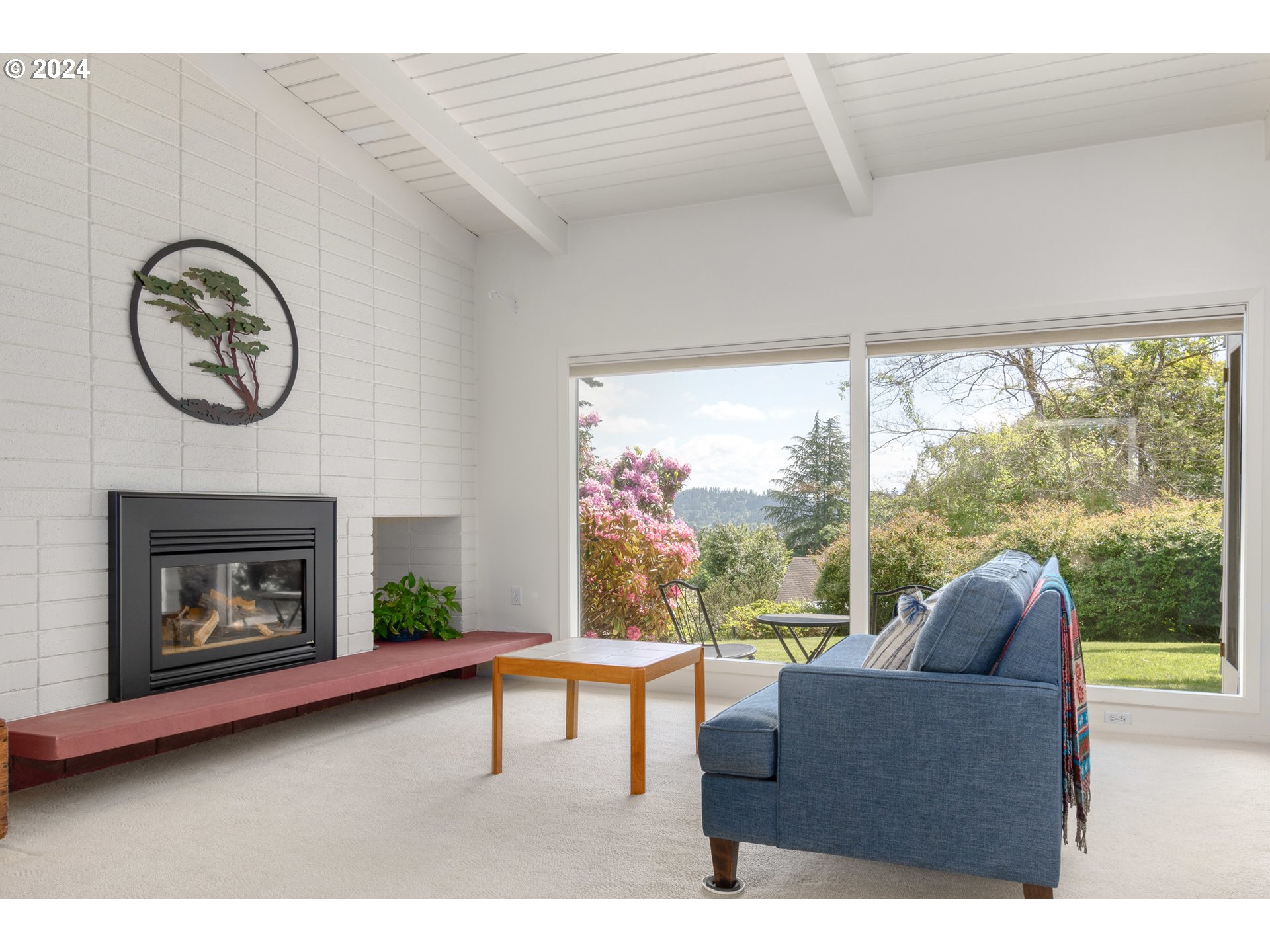 3430 View Lane Eugene, OR 97405 - Photo 11 of 48 a living room with furniture a fireplace and a large window