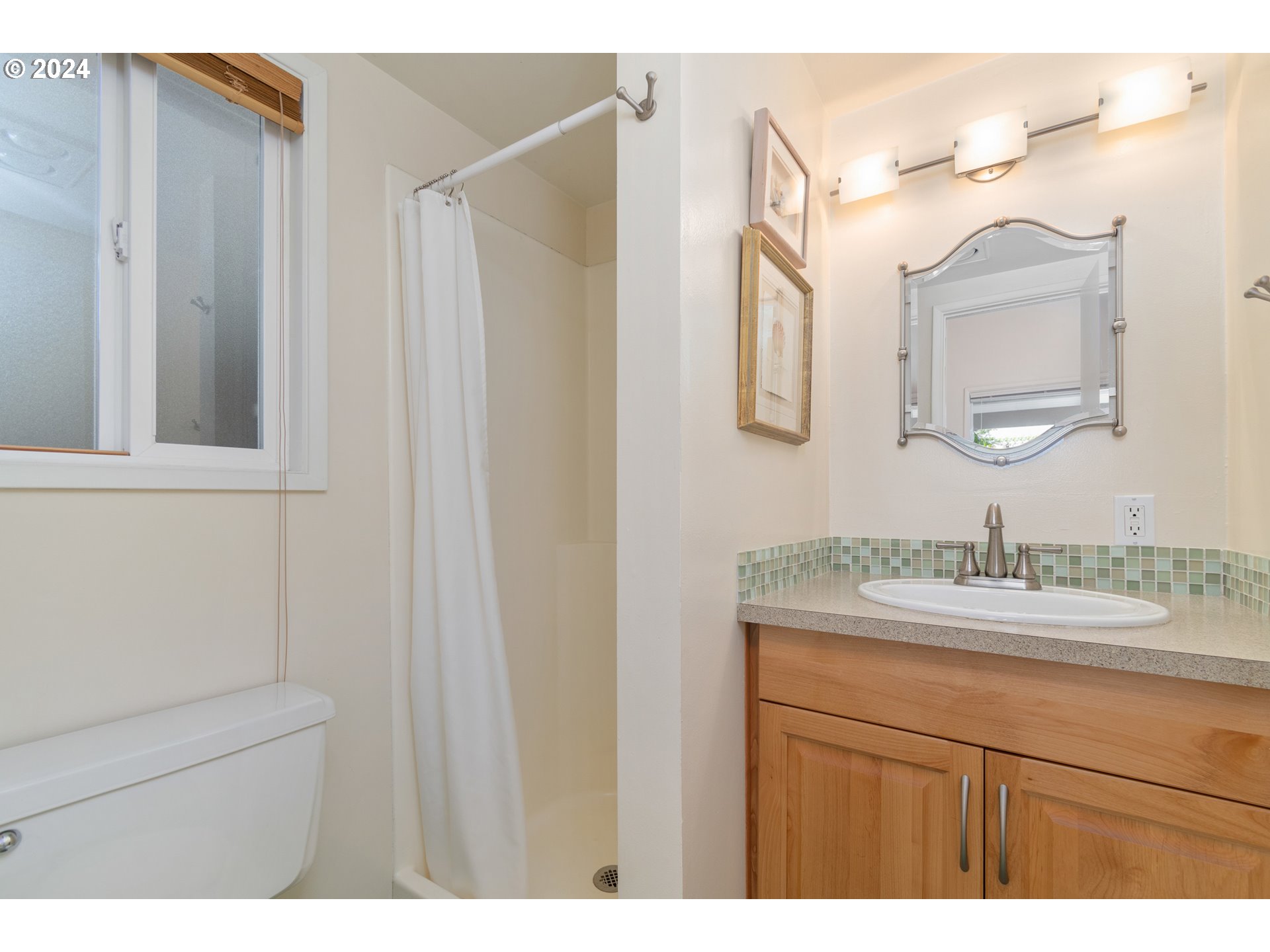 3430 View Lane Eugene, OR 97405 - Photo 27 of 48 a bathroom with a sink vanity and a mirror
