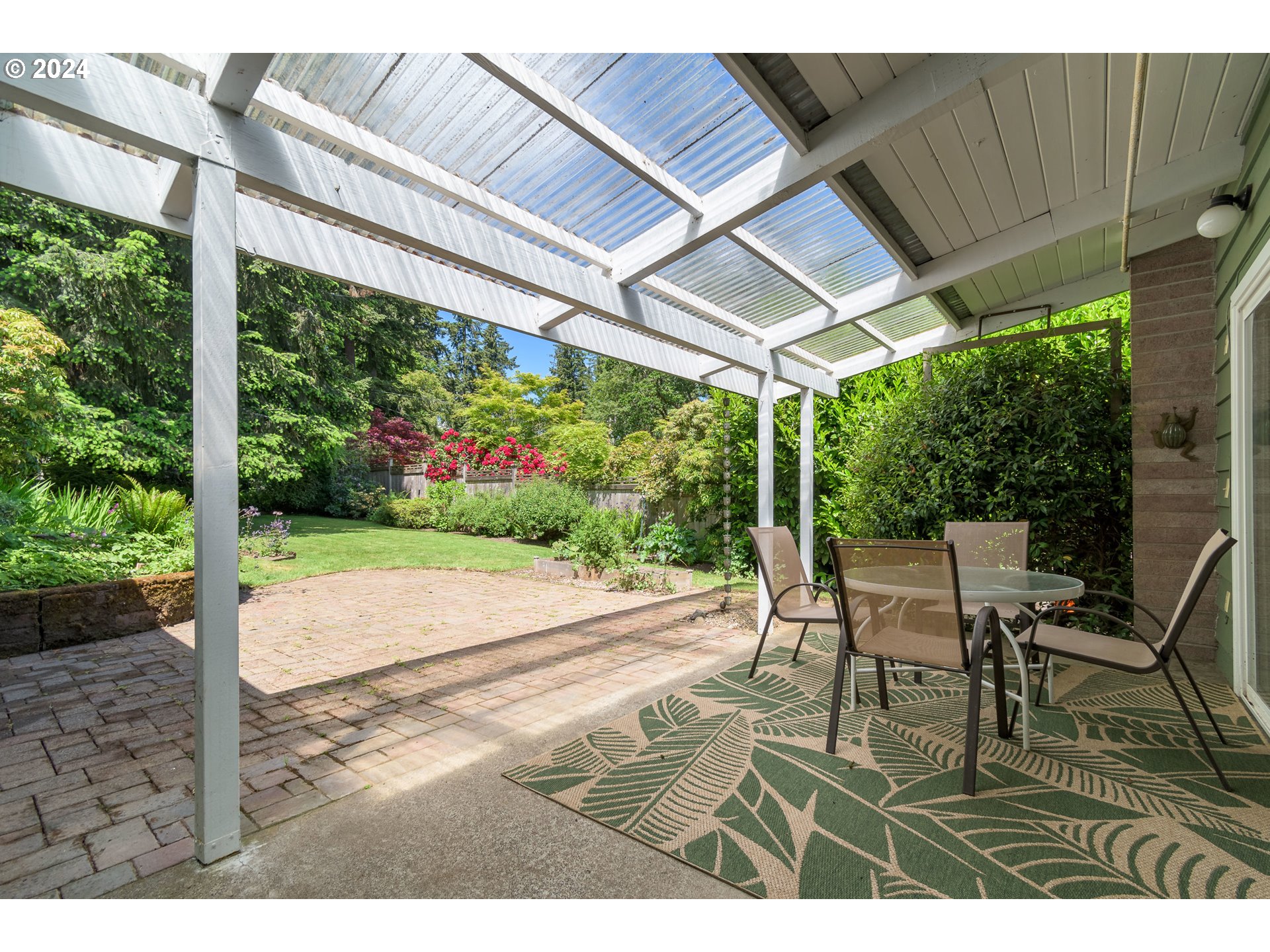 3430 View Lane Eugene, OR 97405 - Photo 34 of 48 a view of a patio with table and chairs with wooden floor and fence