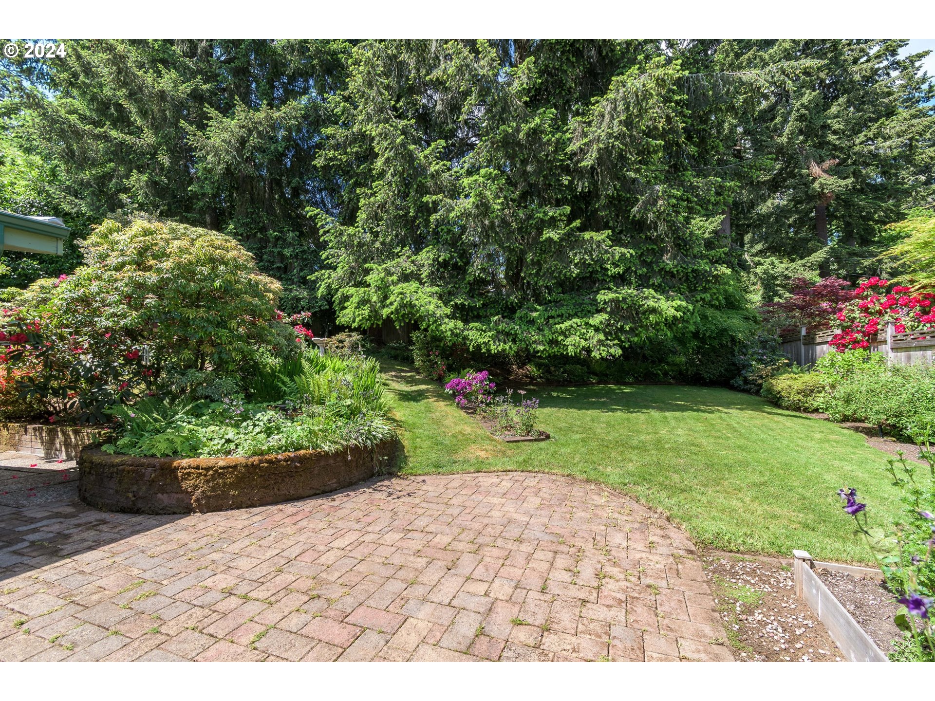 3430 View Lane Eugene, OR 97405 - Photo 35 of 48 a view of a backyard with potted plants and large trees