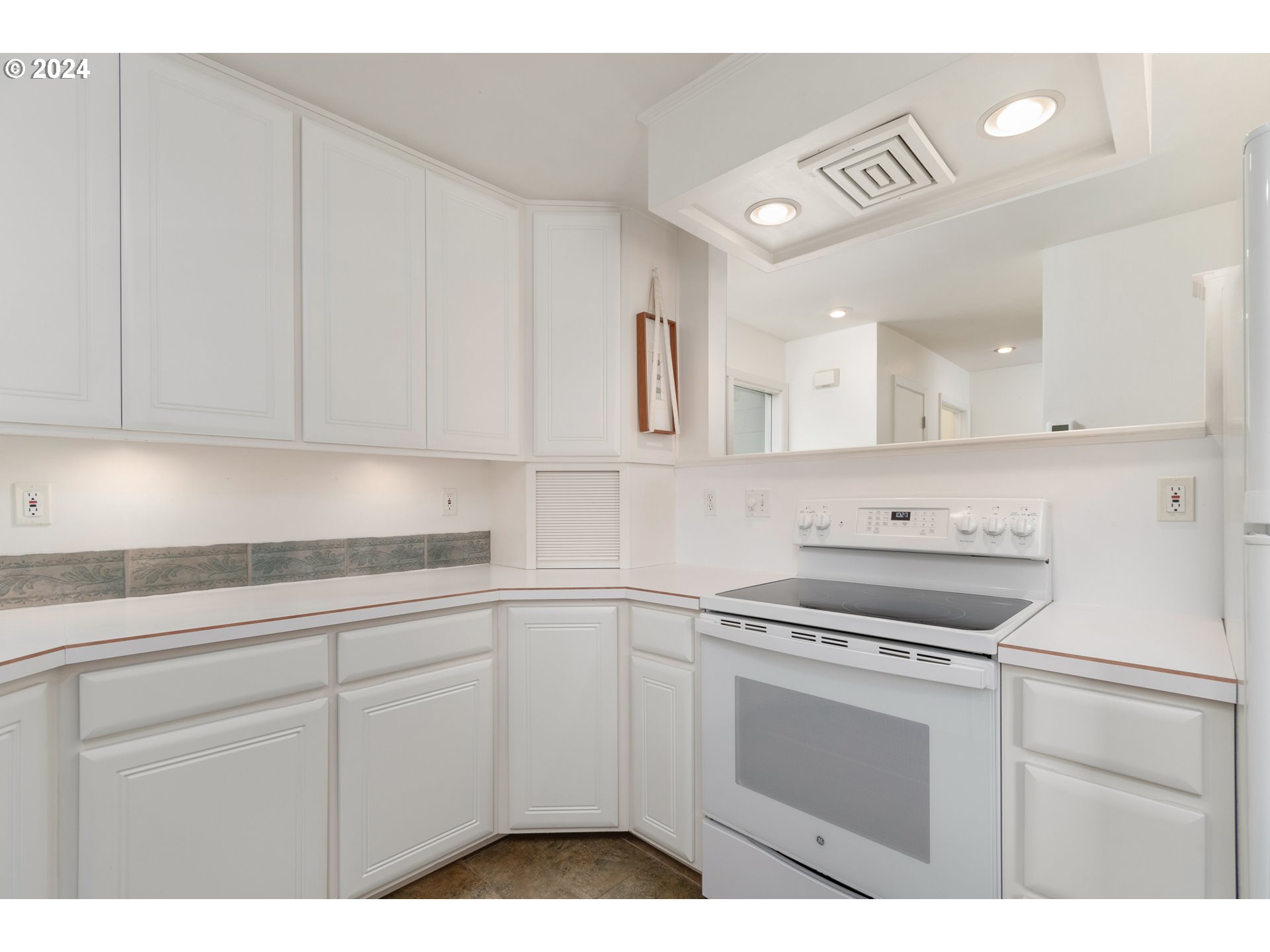3430 View Lane Eugene, OR 97405 - Photo 8 of 48 a kitchen with white cabinets a sink and dishwasher