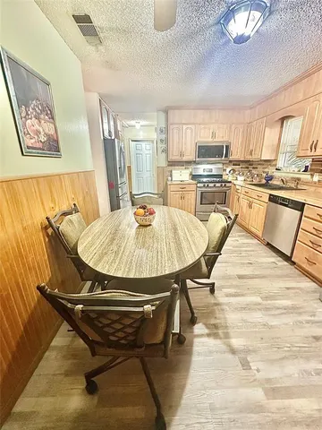 a dining room with a table and chairs