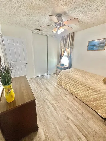 a bedroom with a large bed and a window