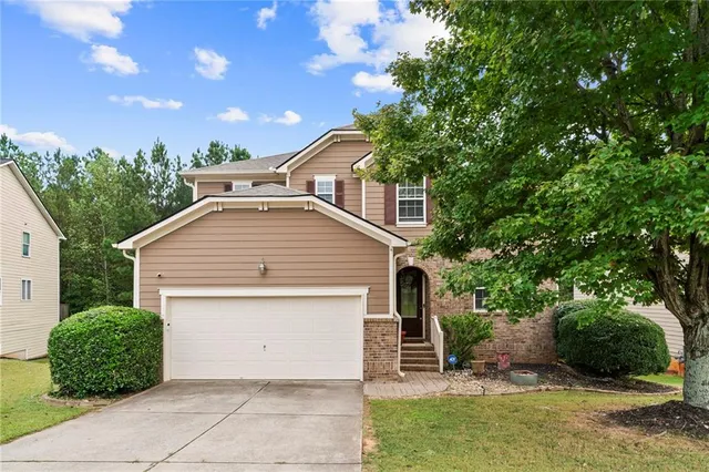 a front view of a house with a garden