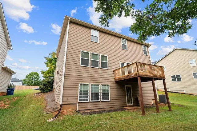 a bedroom with a bed and a chair