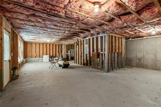 a bathroom with a granite countertop sink a toilet and a mirror