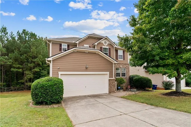 a front view of a house with a yard and garage